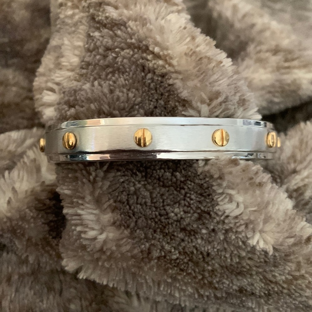 Henri Bendel silver bracelet with gold nail tops. Rivets on each end.